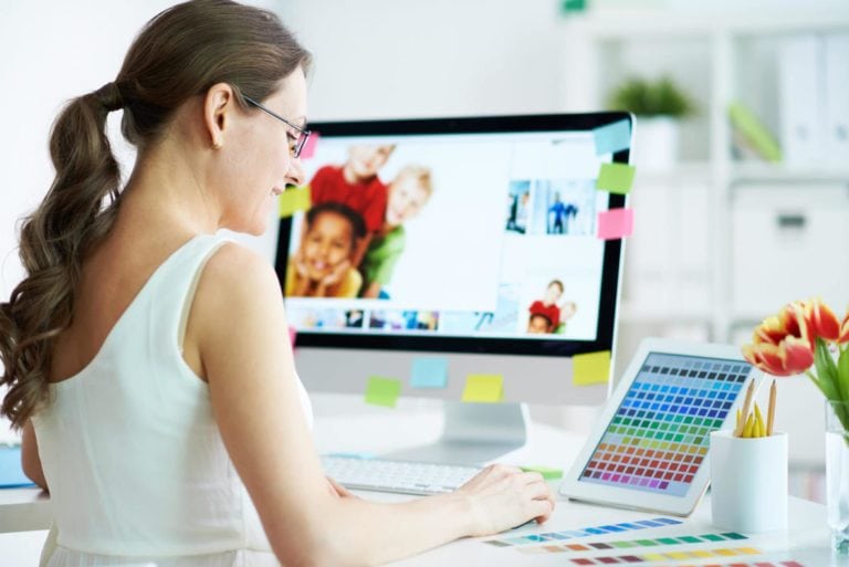 Portrait of pretty female designer working with colors at home