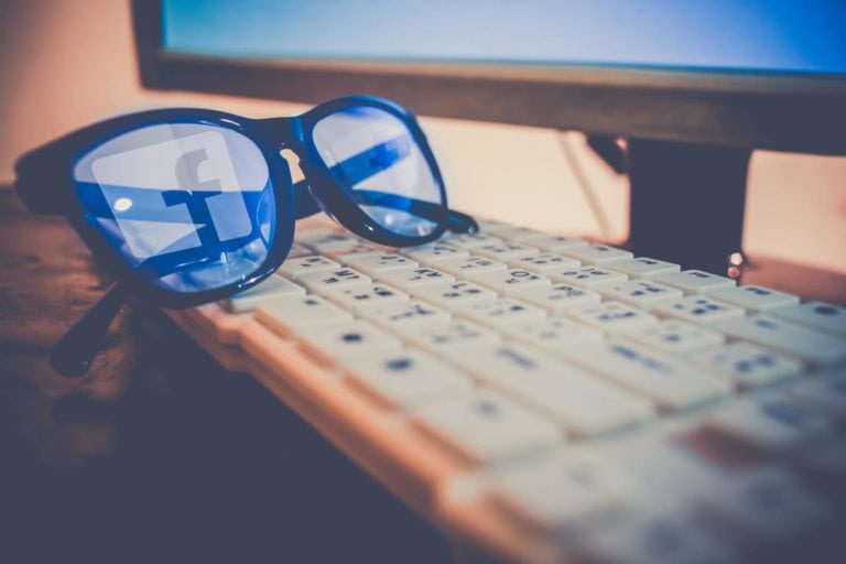 Facebook logo reflection on a  glasses.